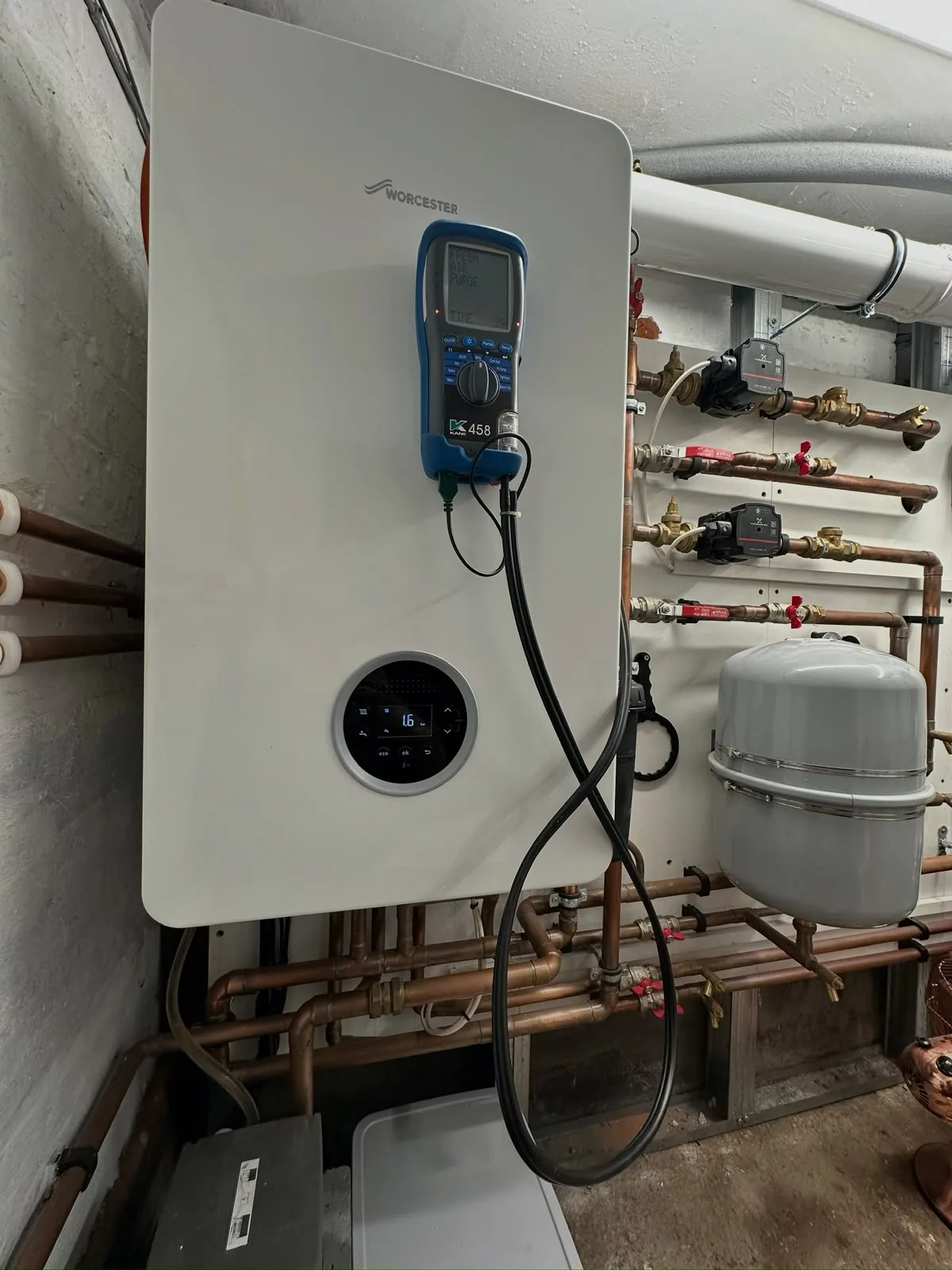 Worcester Bosch boiler being serviced with a Kane flue gas analyser during an annual gas safety check